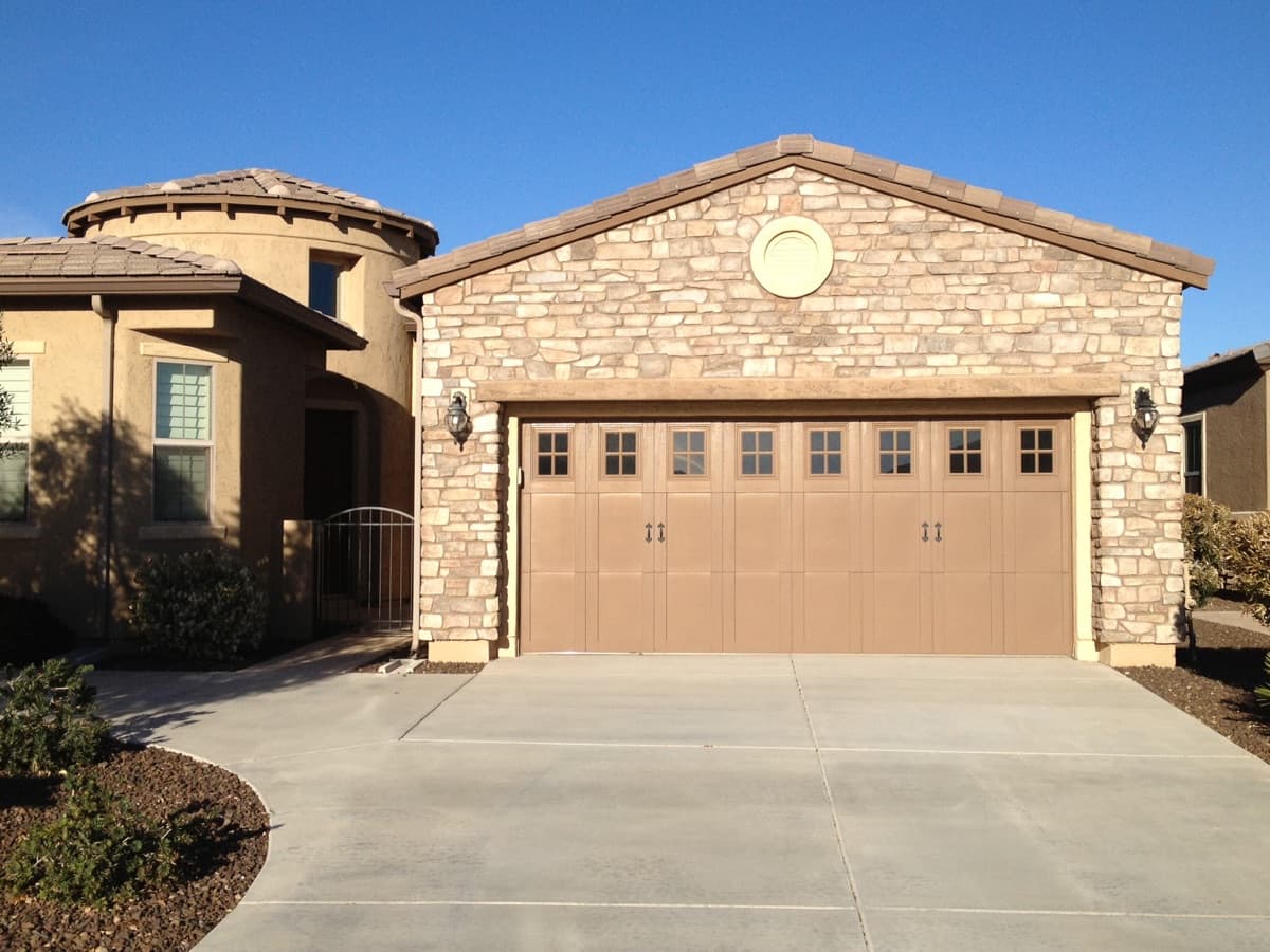 Double garage door on a modern suburban house with a stone facade