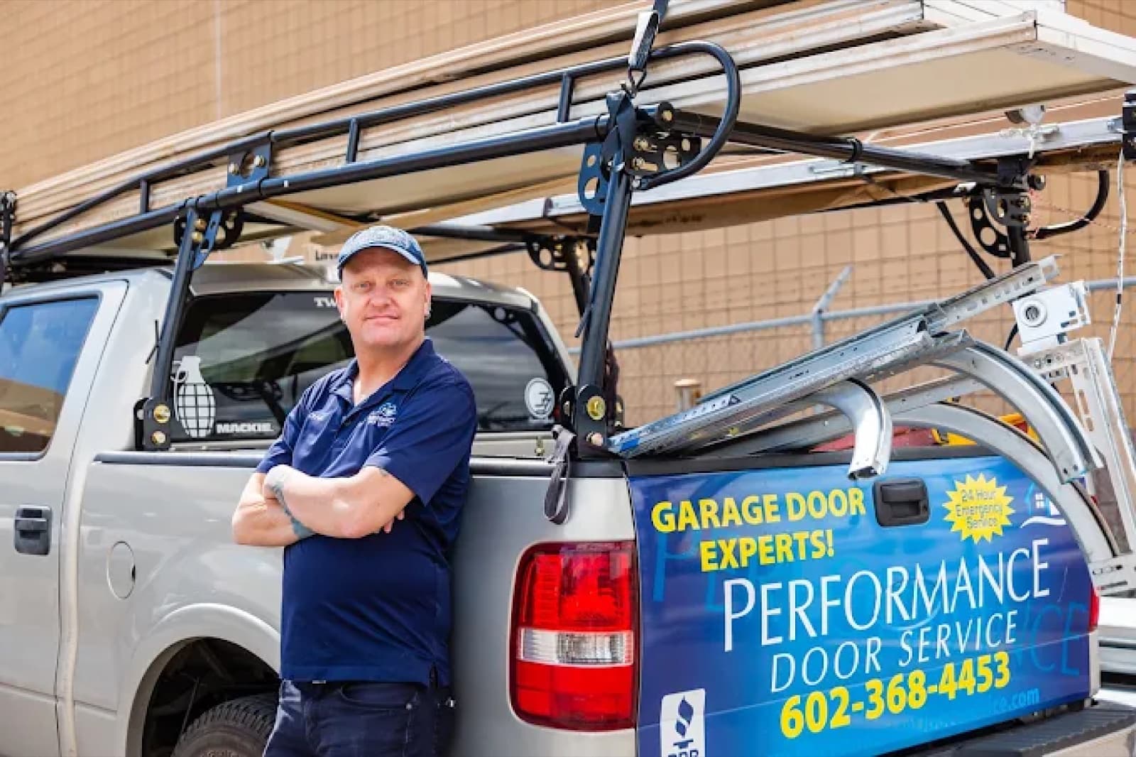 Craig Daley standing beside a branded Performance Door Service truck